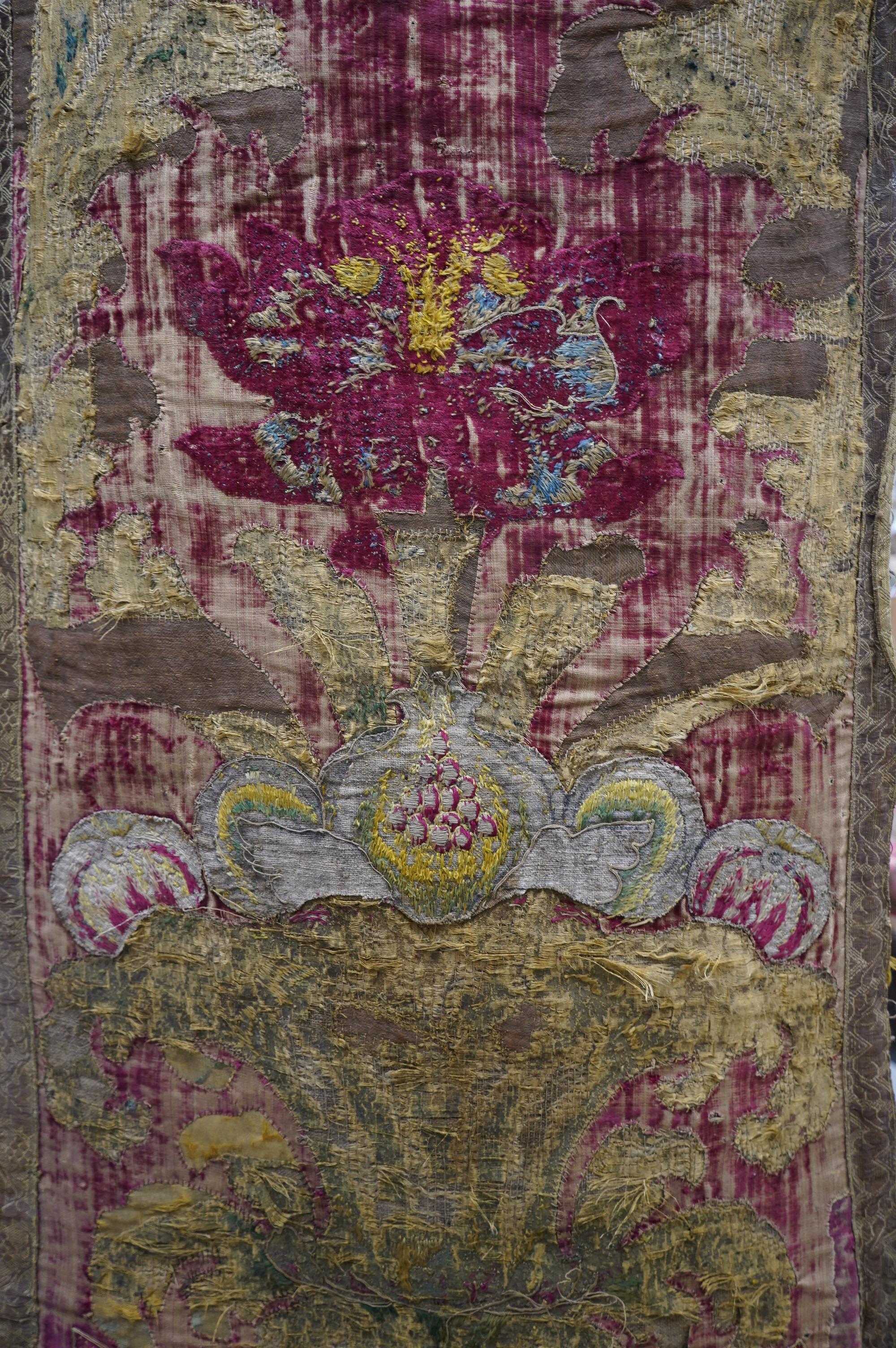 A fine Italian Renaissance style velvet, embroidered and appliqué wall hanging, originally part of a pilaster hanging, made with crimson silk velvet, gold appliqué and colourful polychrome silk embroideries of parrots an